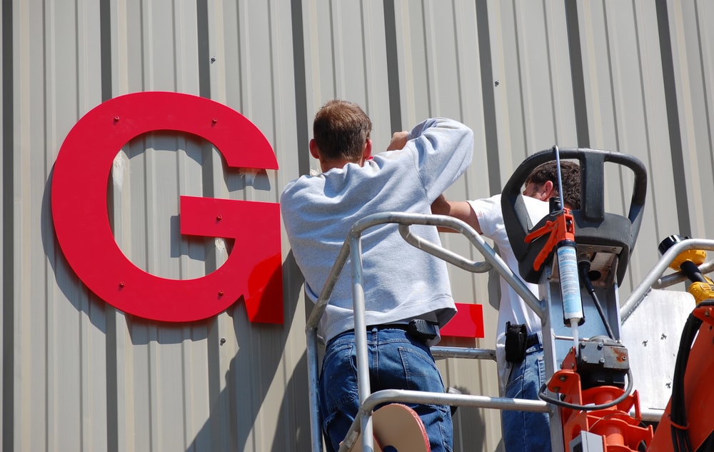 workers-installing-letters-of-a-sign-min_orig